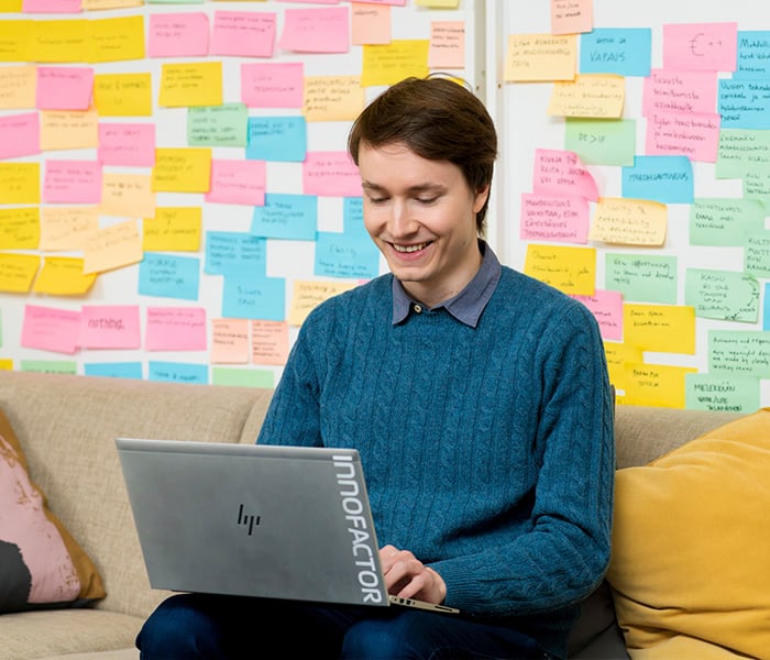 KSP person sitting in front of a colorful wall of post-its 700x600